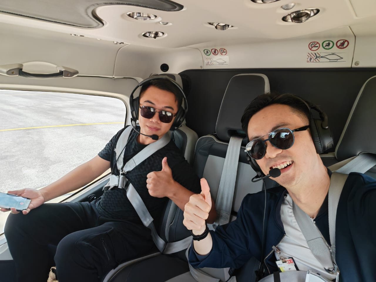Marcus Teoh hosting a China-based travel creator exploring Malaysia as a regional base, inside a private helicopter in Kuala Lumpur